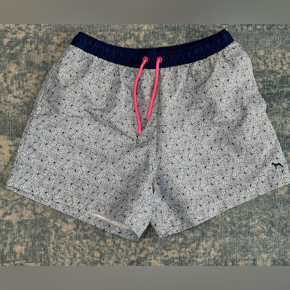 Blue and white floral print swim shorts by Victor